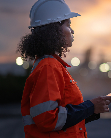 A woman with a hardhat in front of a blurry background